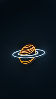 A neon light depiction of a planet with rings, resembling Saturn. The planet is illustrated with glowing orange and yellow lines, while the rings are represented by bright white neon outlines against a dark background.