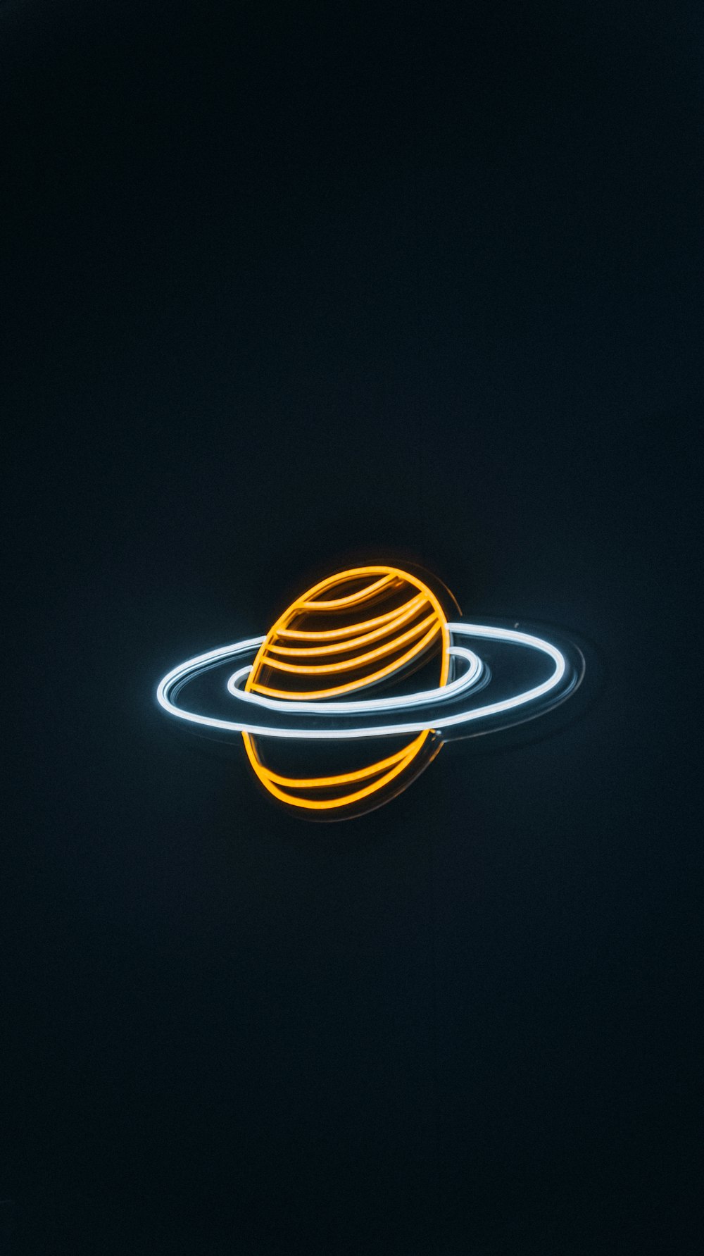 a light painting of a saturn in the dark