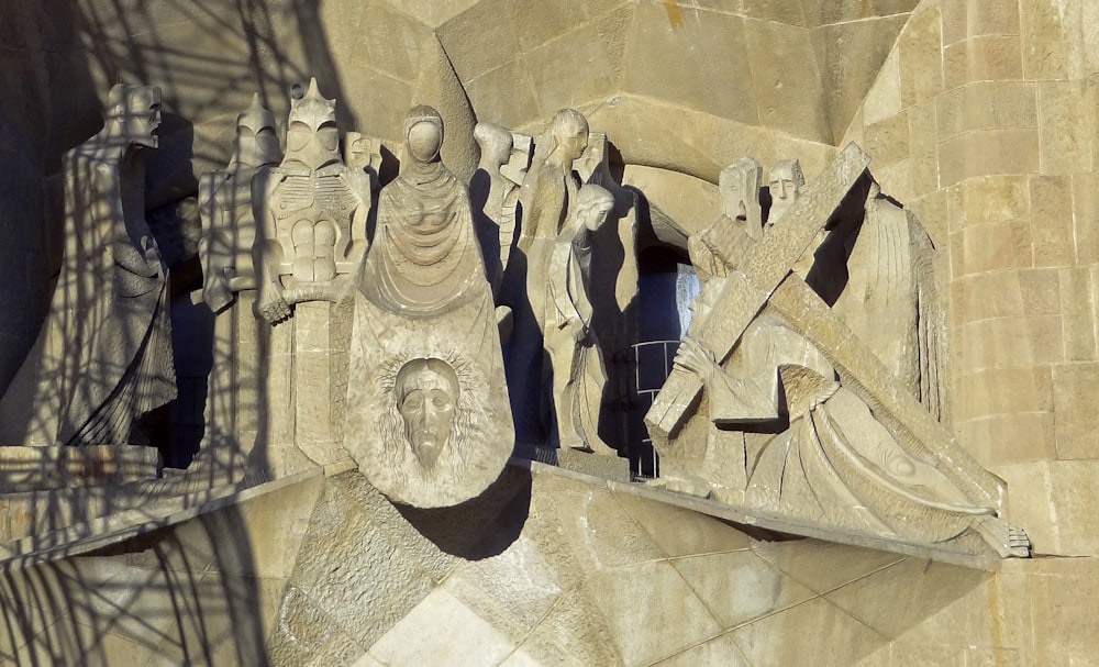 a statue of a group of people on a building