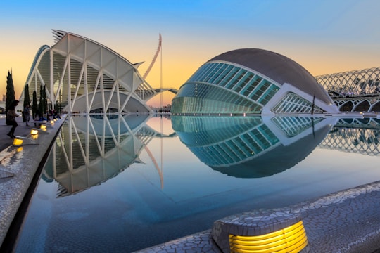 A stunning 3D render showing a modern villa at sunset with glowing blue accents highlighting architectural details.