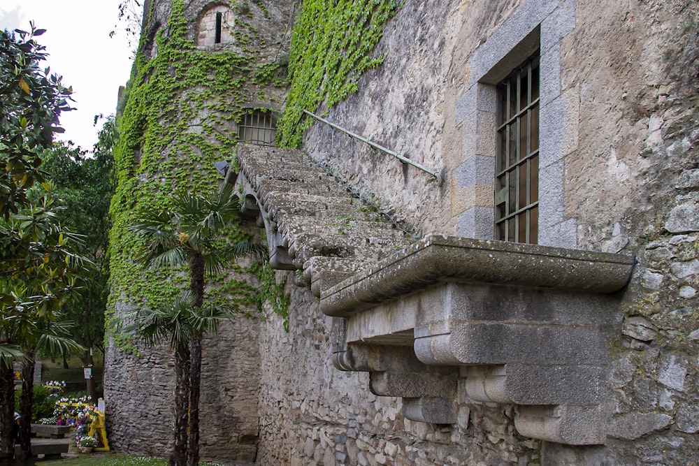 a stone building with a window and a balcony