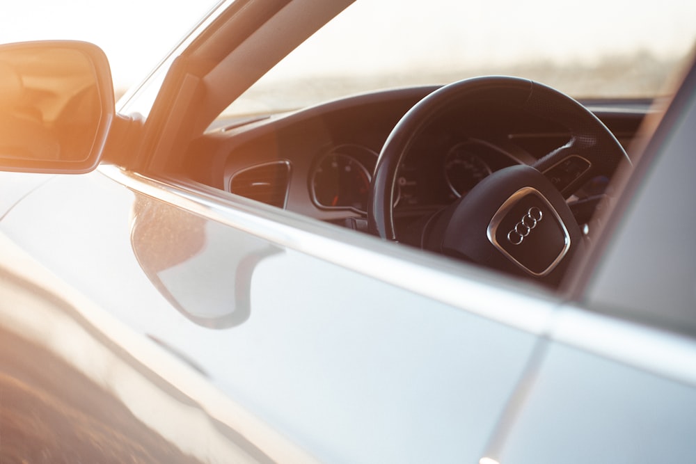 a close up of a car's steering wheel and dashboard