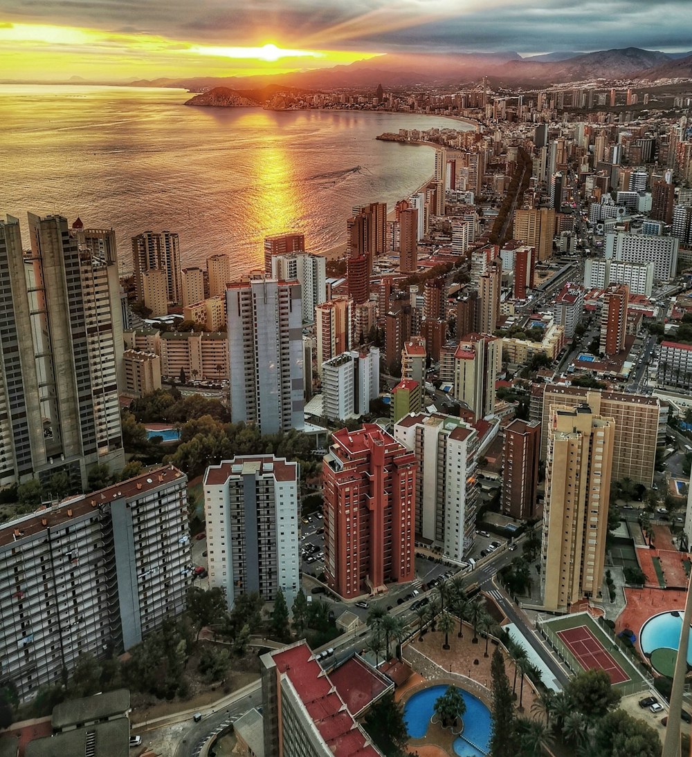 a view of a city with a body of water in the background