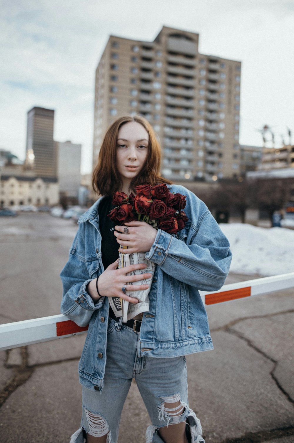 a woman holding a bouquet of flowers in her hands