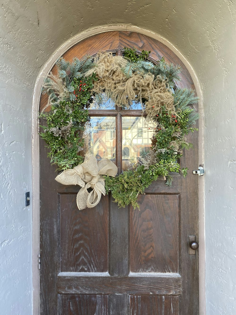 a wooden door with a wreath on it