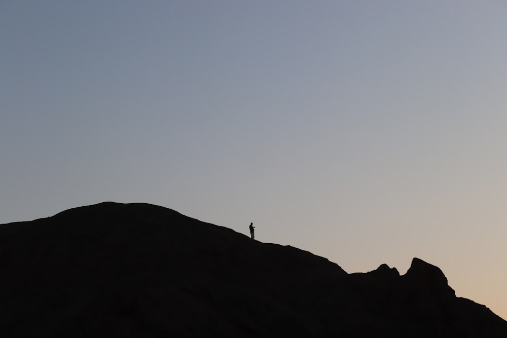a person standing on top of a hill