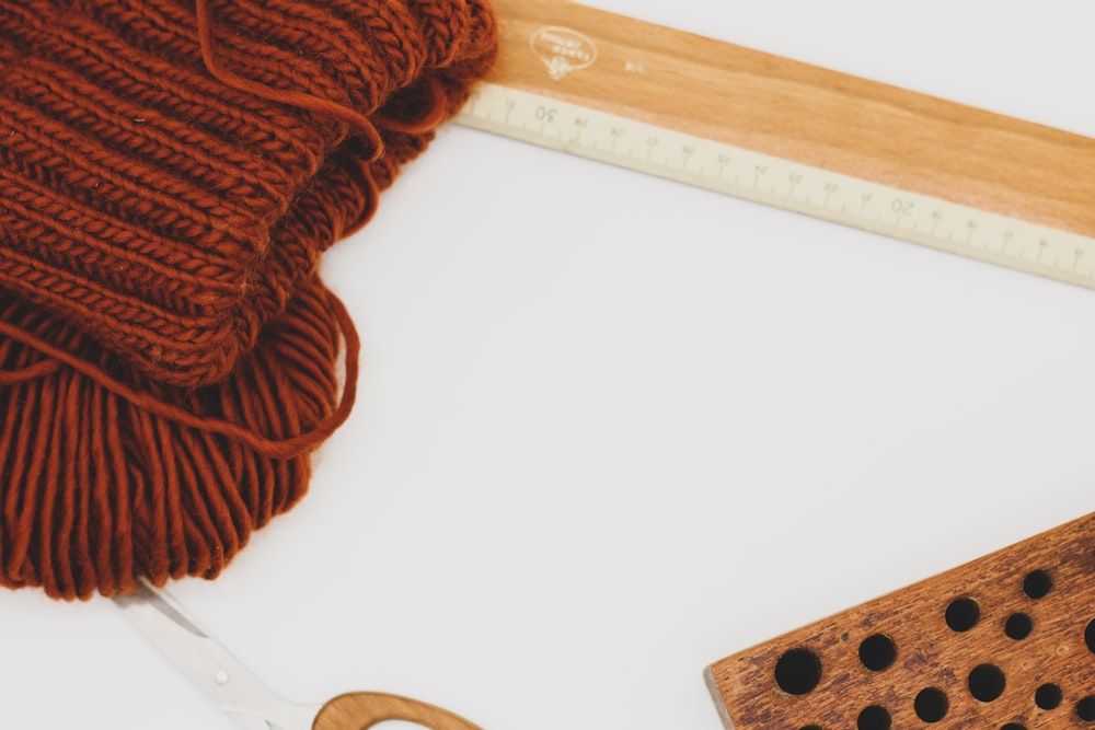 a pair of scissors next to a ball of yarn