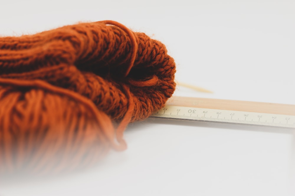 a skein of yarn next to a ruler