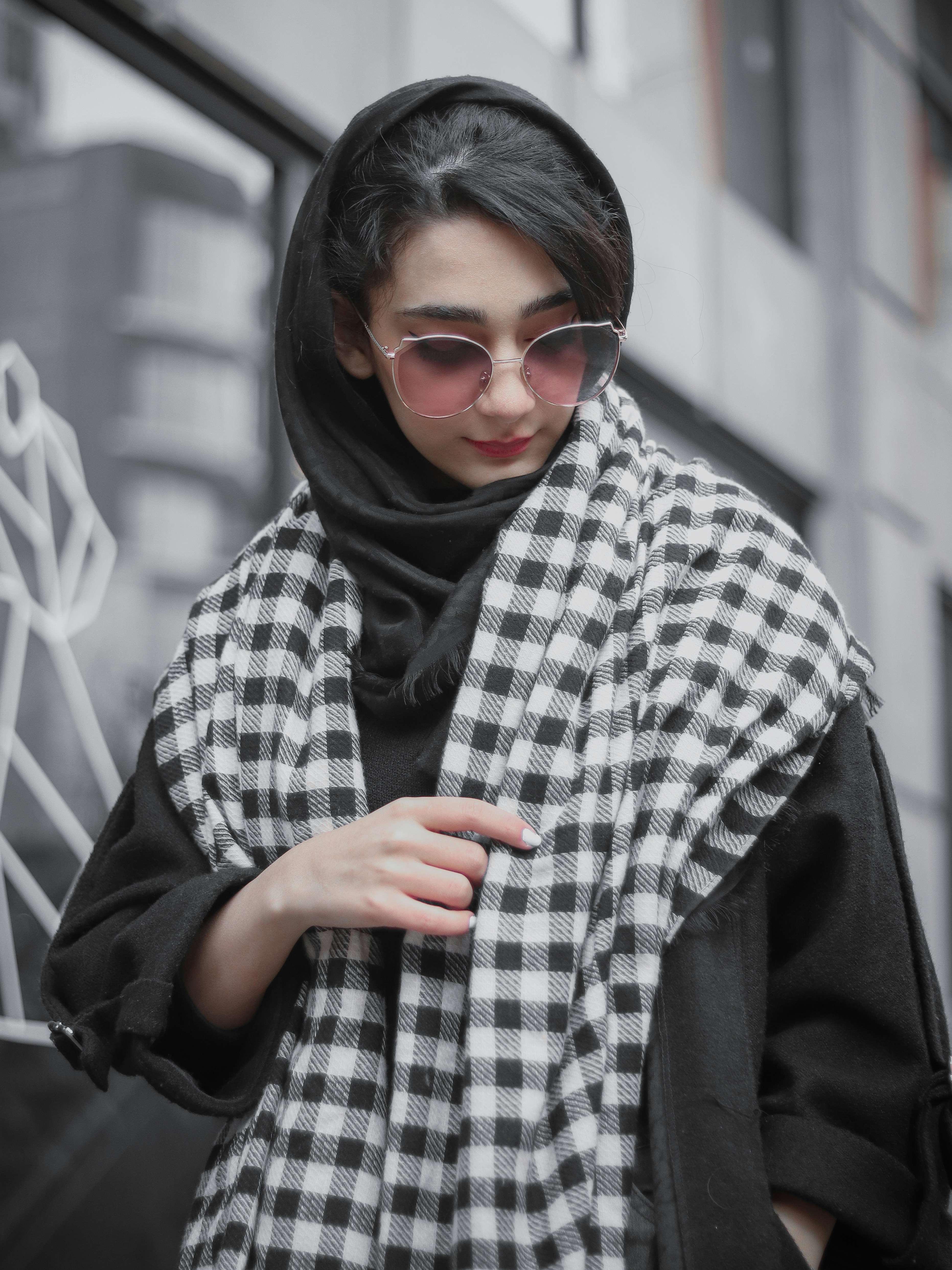 a woman wearing a black and white checkered scarf
