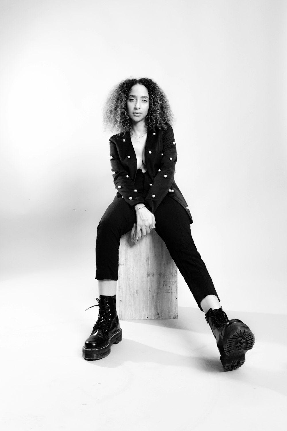 a woman sitting on top of a wooden bench