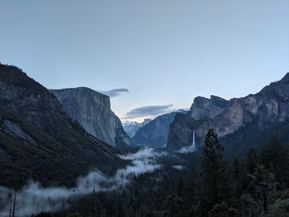 a view of a valley with mountains in the background