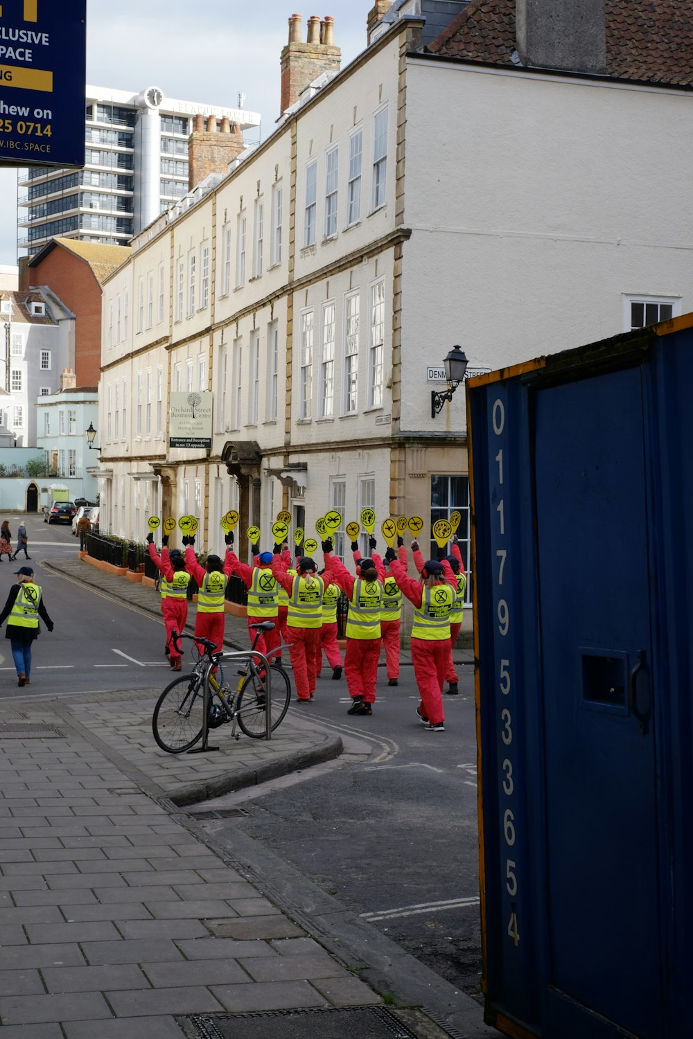 a group of people in red and yellow uniforms on a street