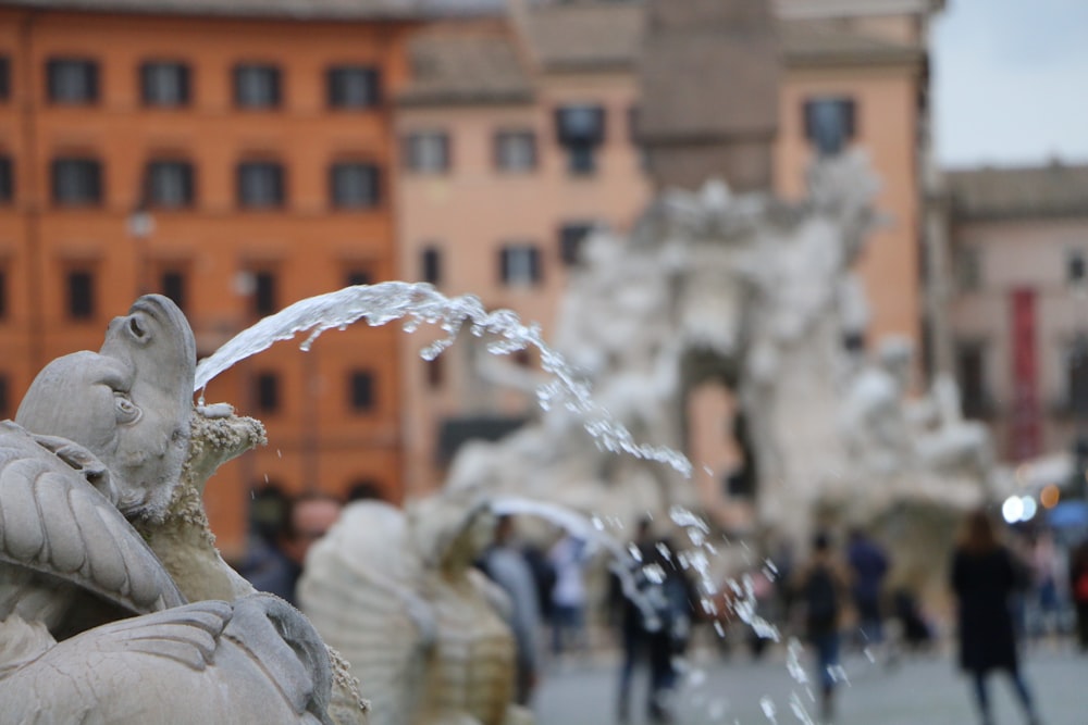 a group of people standing around a fountain