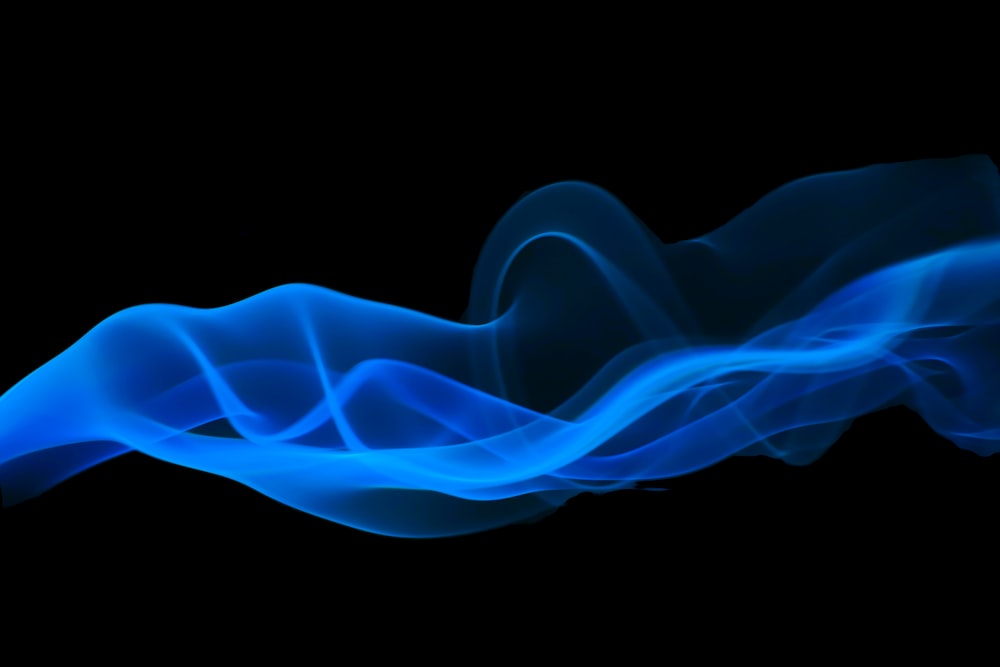 a blue wave of smoke on a black background