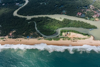an aerial view of a sandy beach and ocean