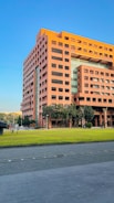 a large orange building sitting on the side of a road