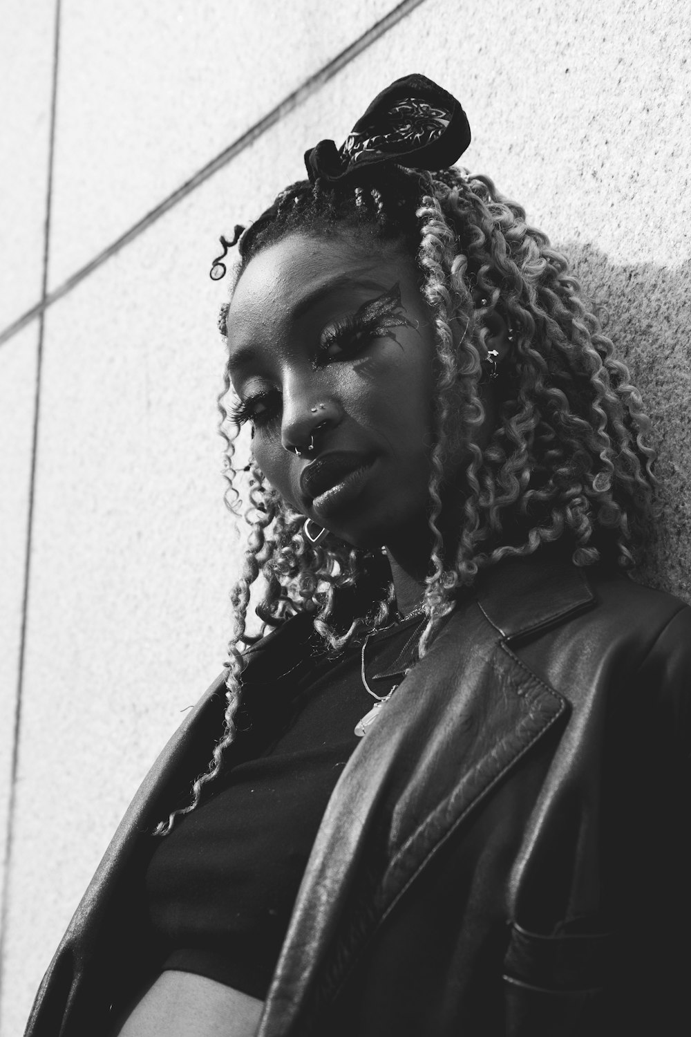 a black and white photo of a woman with braids