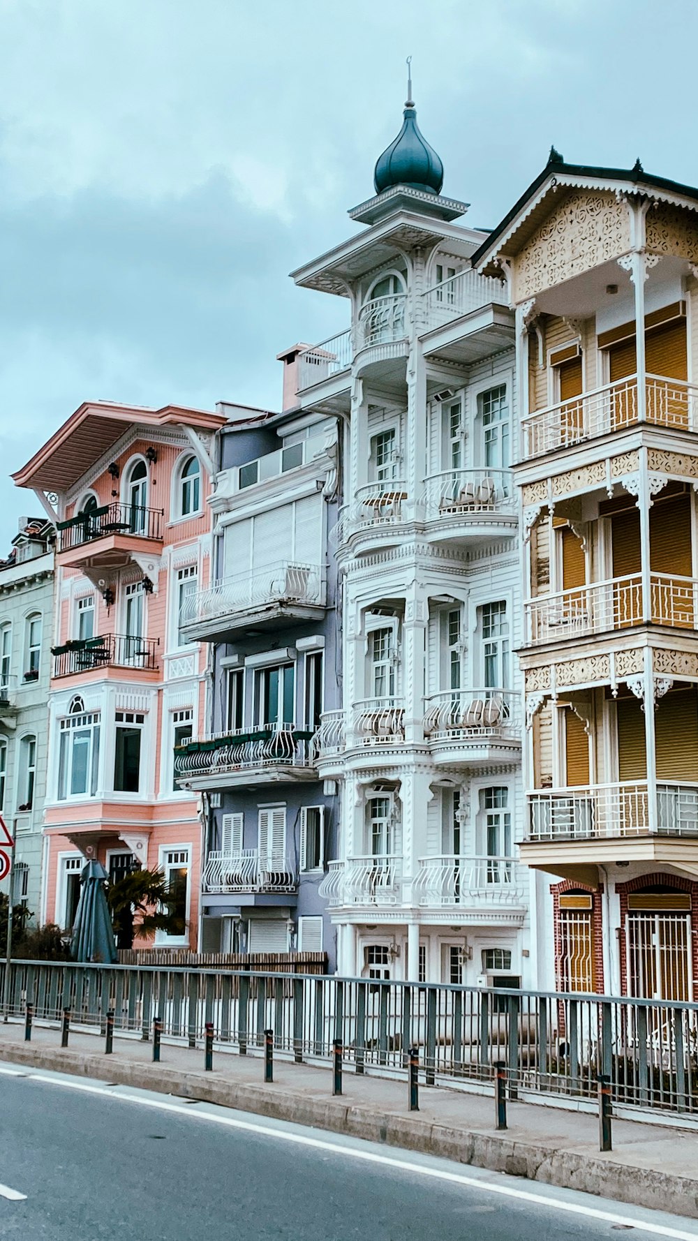 a row of multi - colored buildings along a street