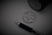 a pen sitting on top of a piece of paper