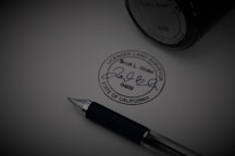 a pen sitting on top of a piece of paper