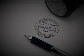 a pen sitting on top of a piece of paper