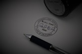 a pen sitting on top of a piece of paper