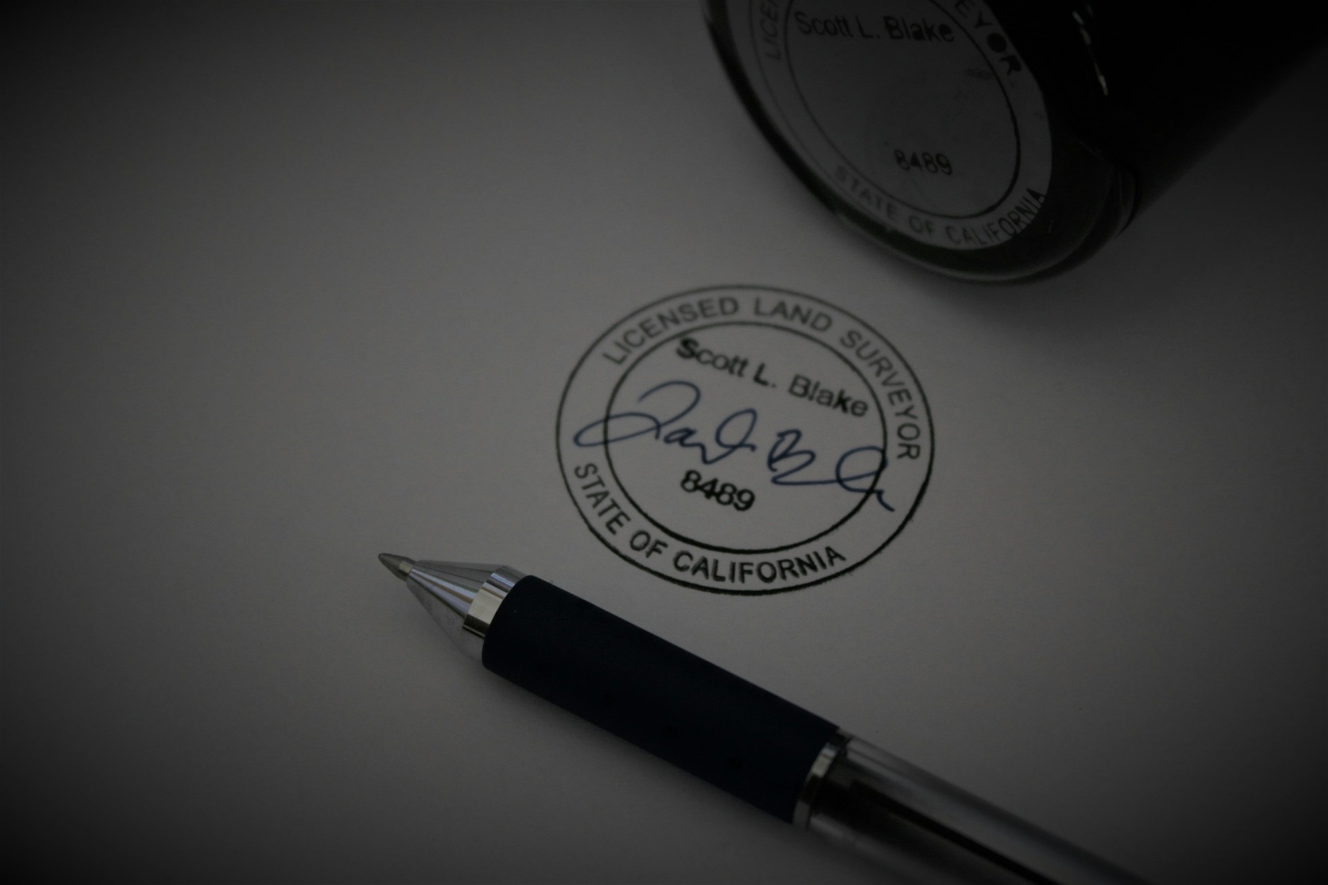 a pen sitting on top of a piece of paper