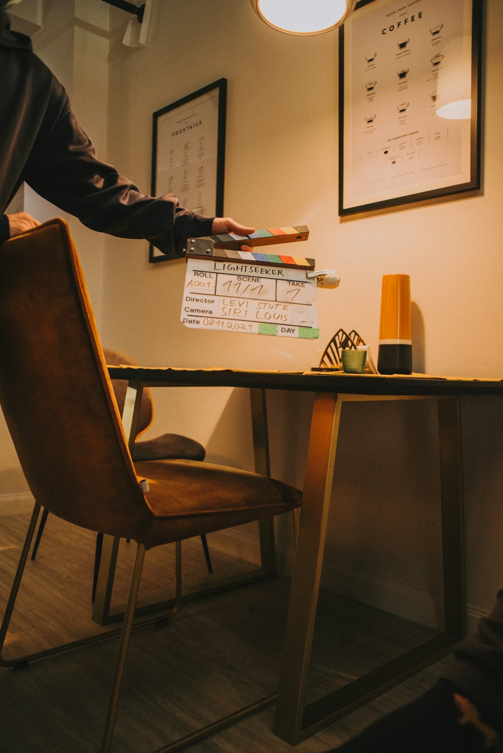 a person standing at a table with a remote control