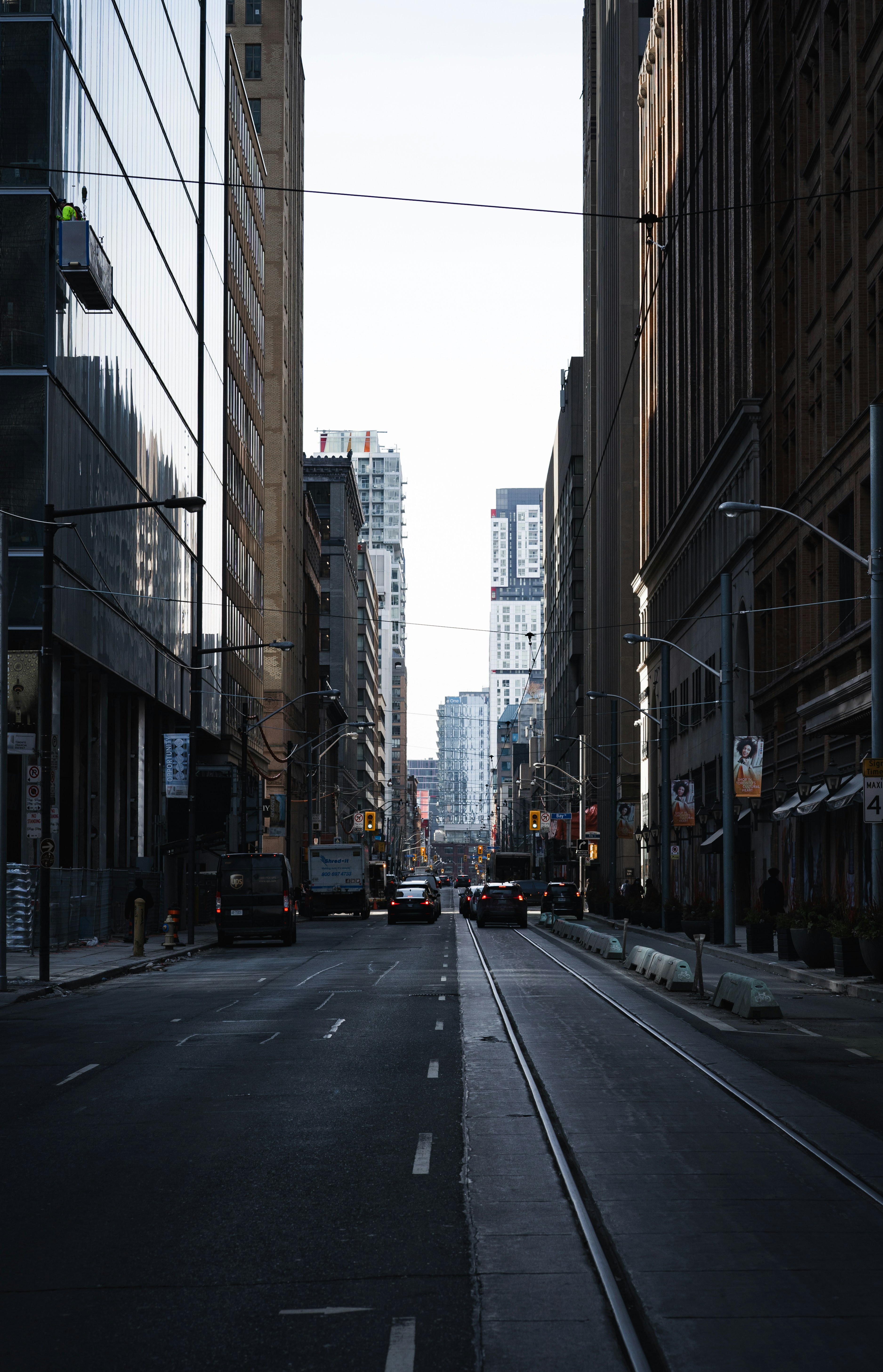 A city street lined with tall buildings and traffic lights photo – Free ...