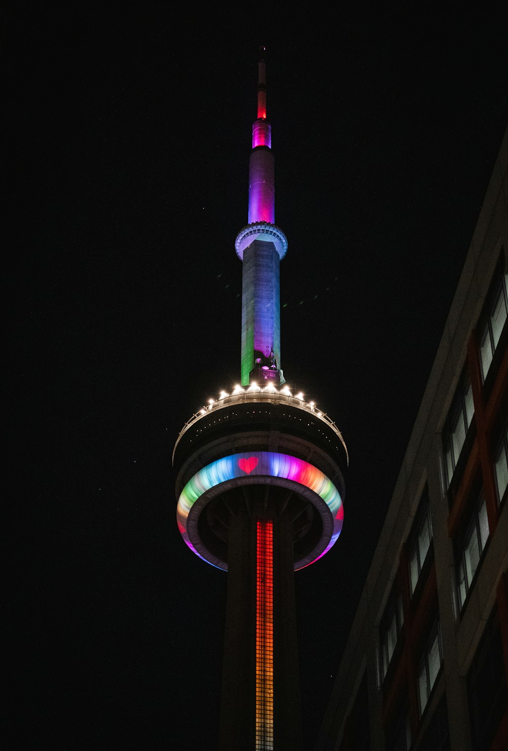a tall tower with a colorful light on it's side