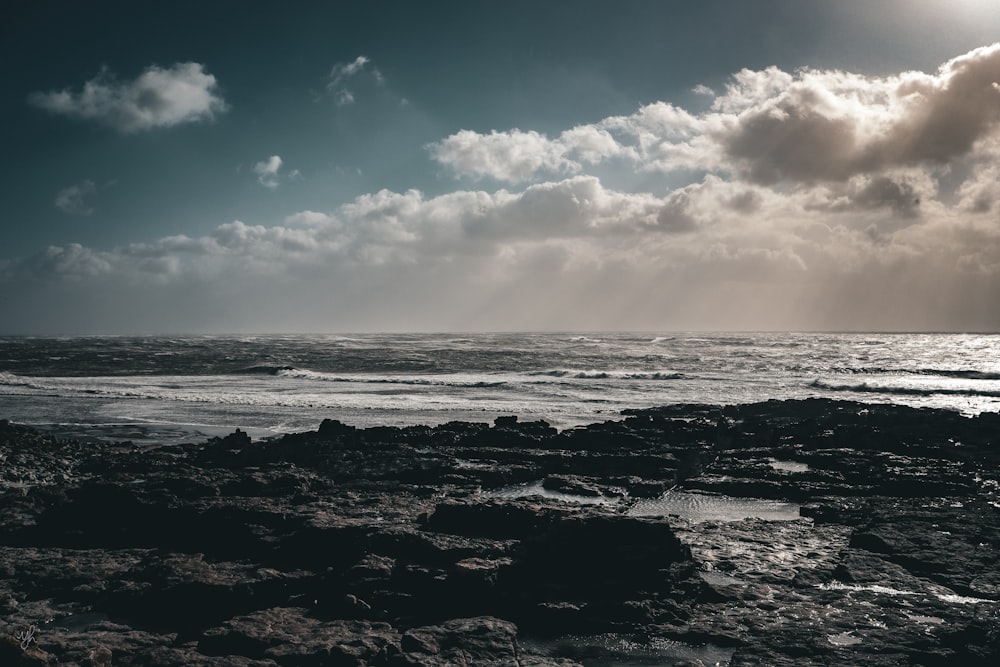 the sun shines through the clouds over the ocean