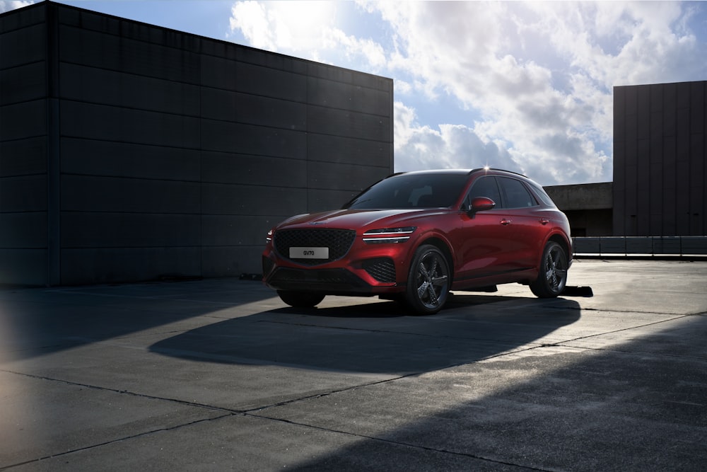 a red suv parked in front of a building