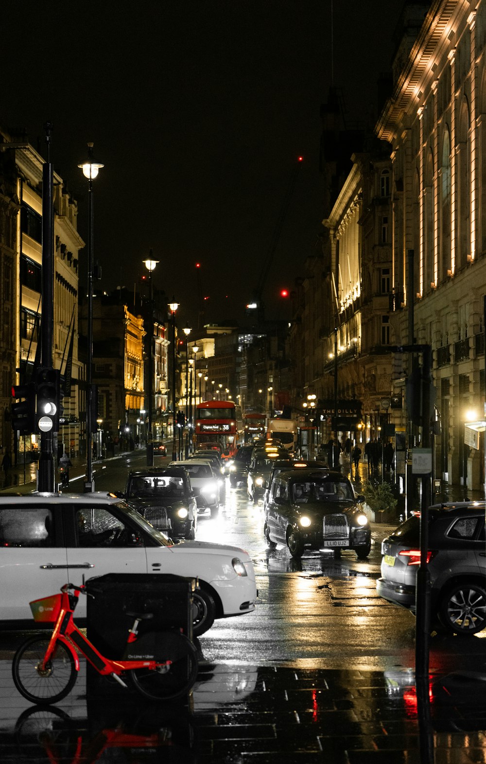 a city street filled with lots of traffic at night