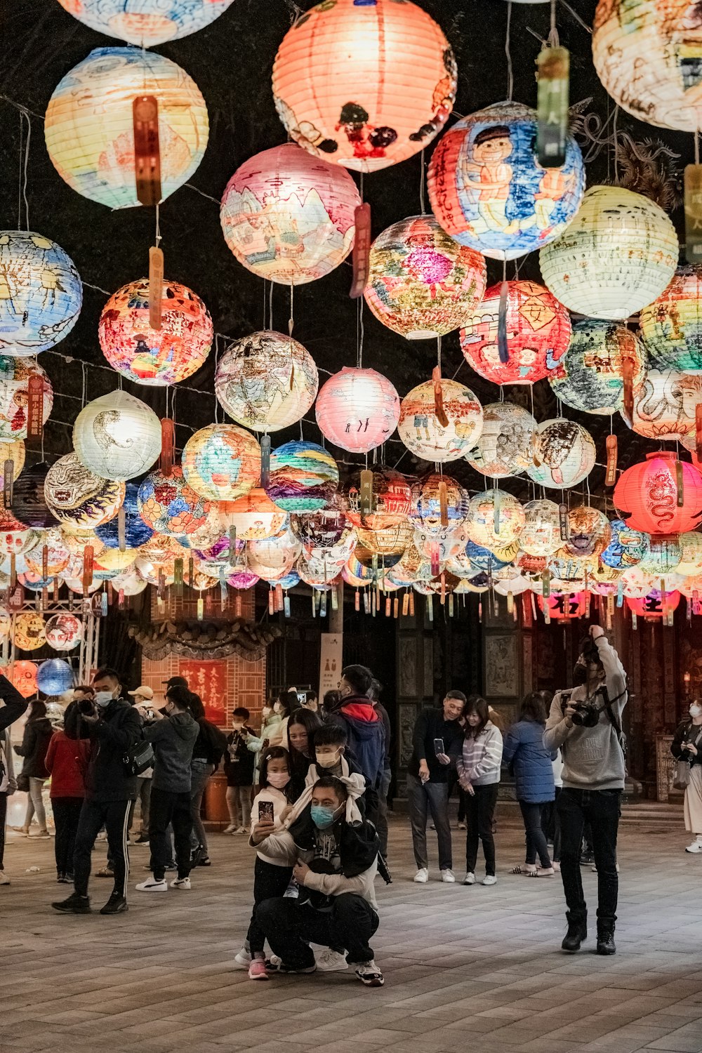 a group of people standing around a bunch of lights