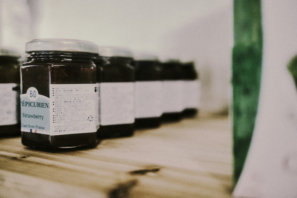 jars of preserves sit on a shelf in a store