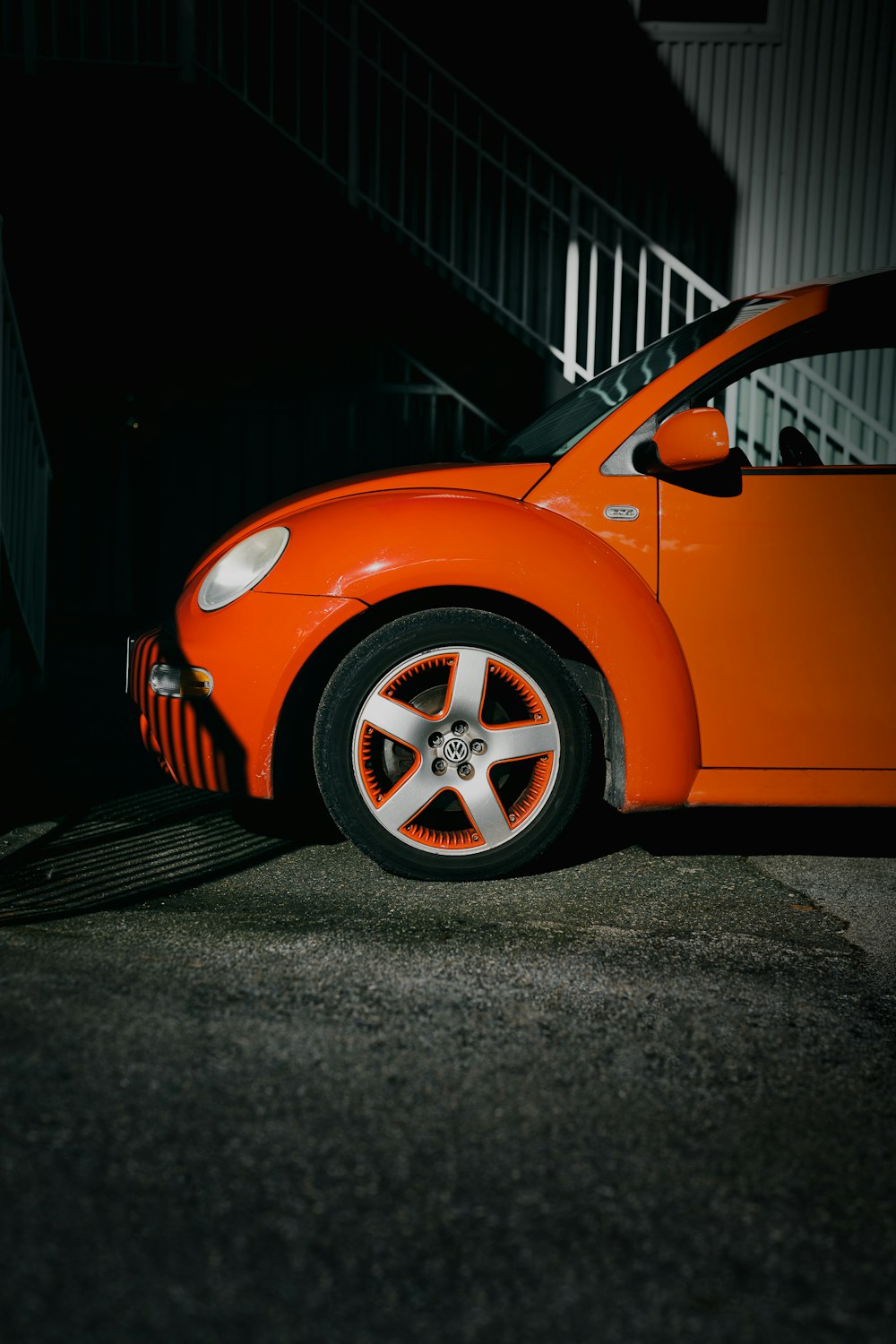 an orange car parked in front of a building