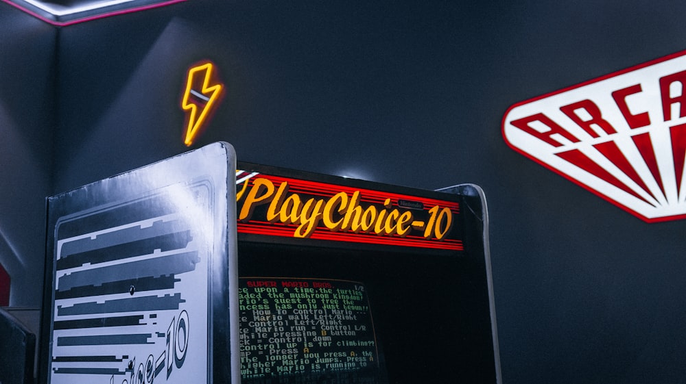 a close up of a vending machine near a neon sign