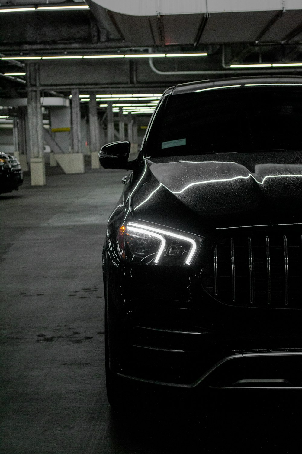 a black car parked in a parking garage