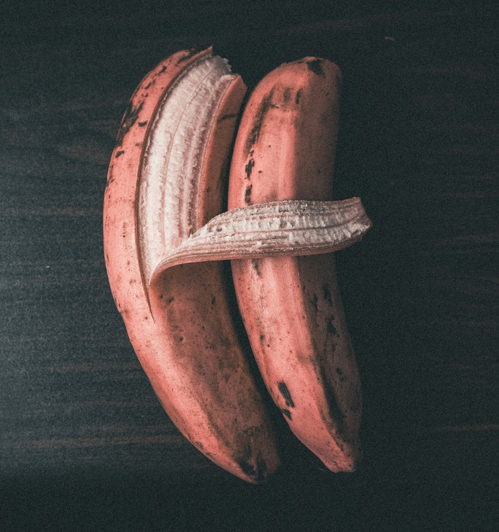 a couple of bananas sitting on top of a wooden table