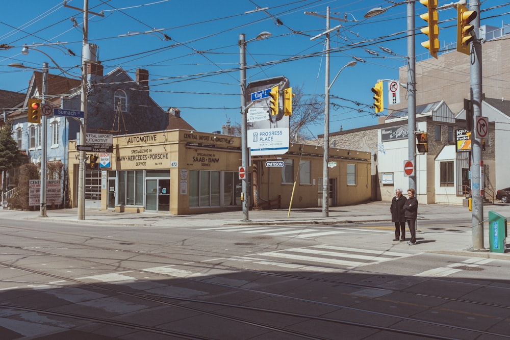 a man standing on the corner of a street