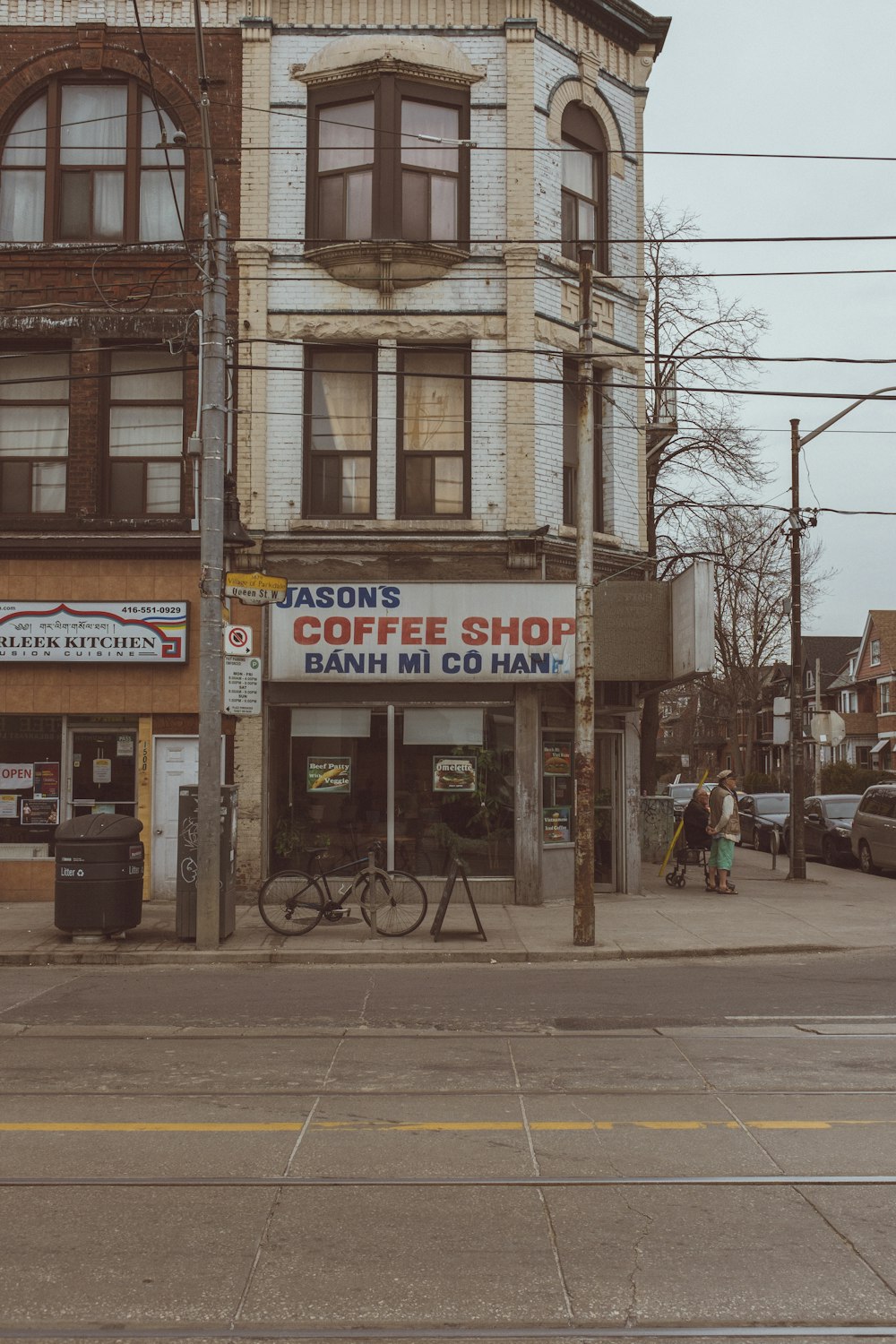 a building on a street corner with a bike parked in front of it