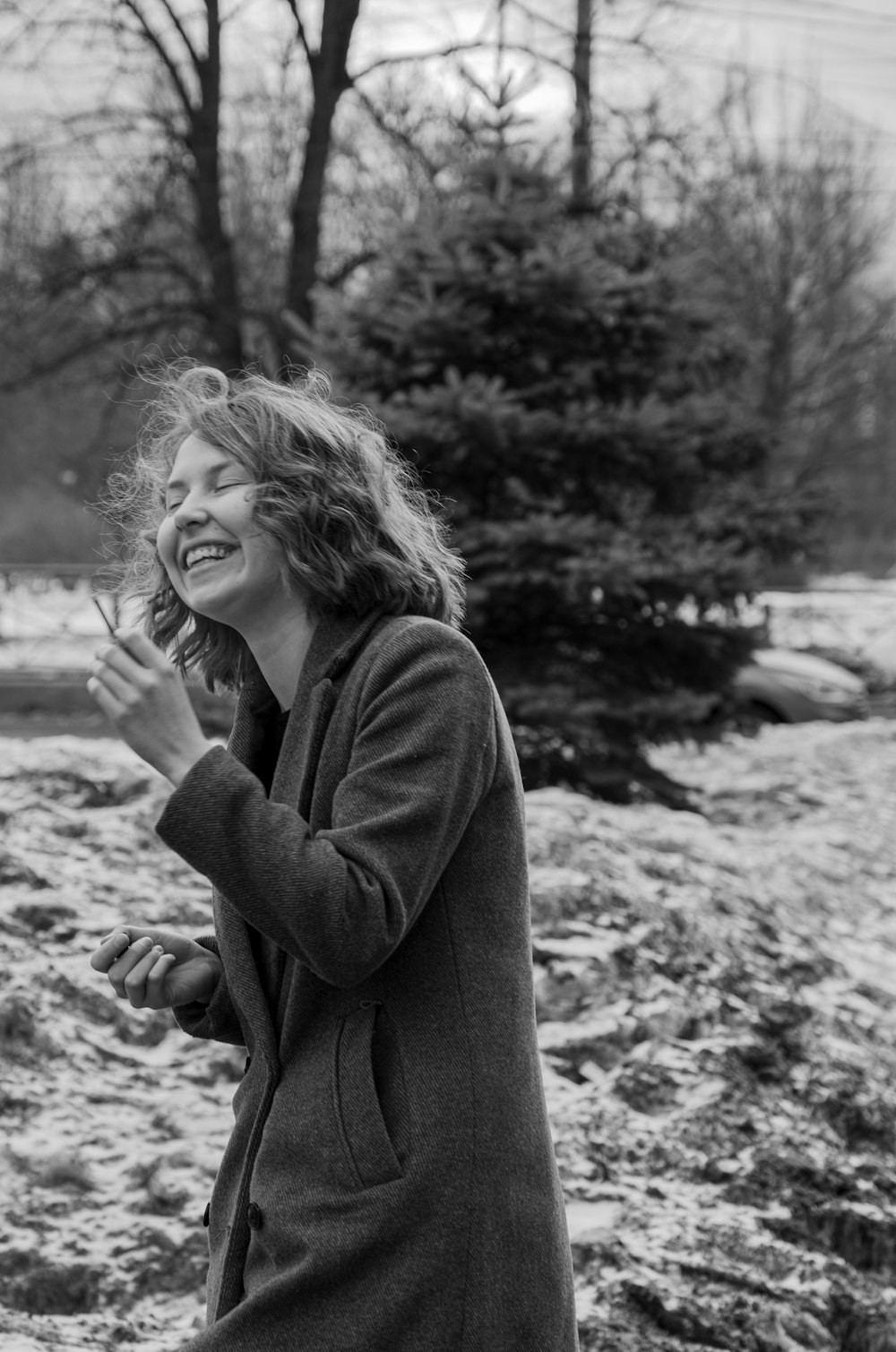 a black and white photo of a woman laughing