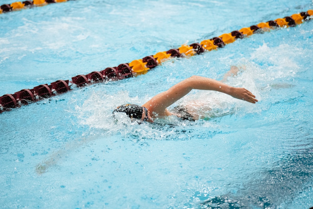 a person swimming in a swimming pool