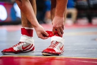 a close up of a basketball player tying his shoes