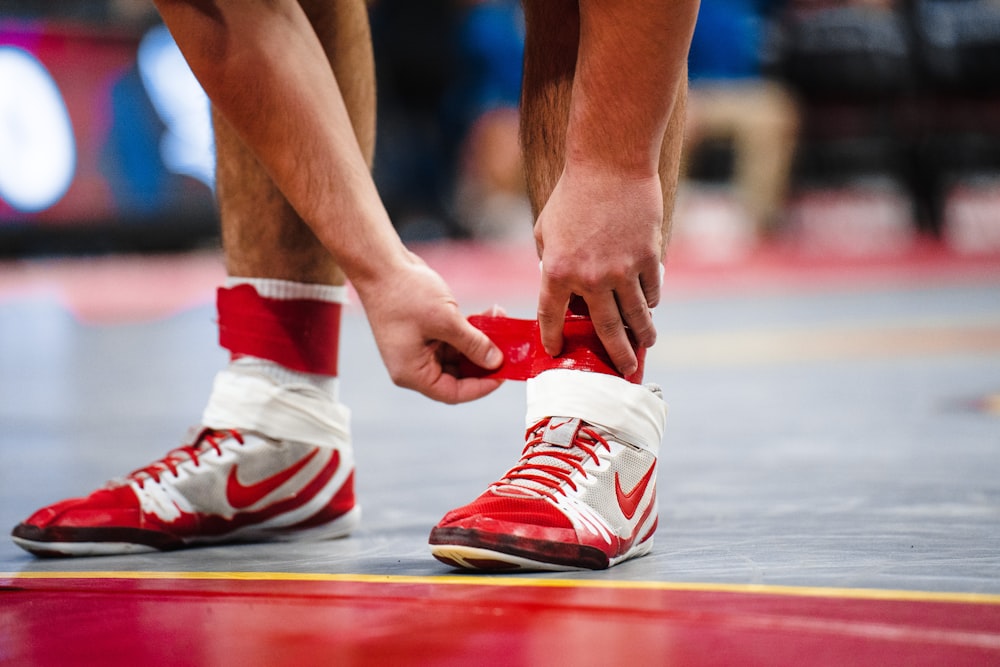 a close up of a basketball player tying his shoes