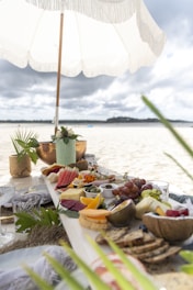 a table set up with food and an umbrella