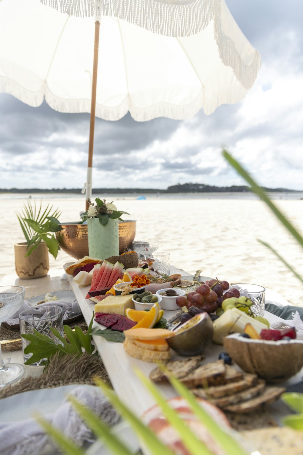 a table set up with food and an umbrella