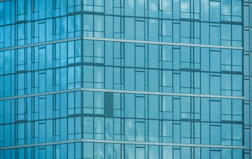 an airplane flying in front of a very tall building