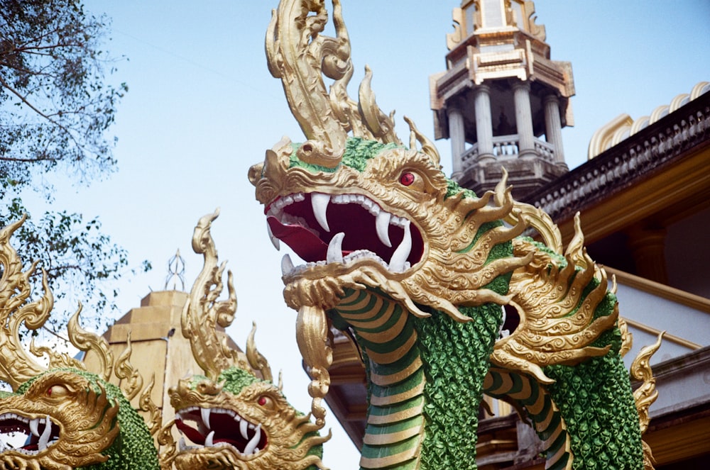 a close up of a dragon statue in front of a building