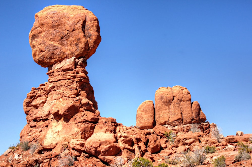 a large rock formation in the middle of a desert